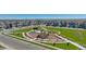 Aerial view of a planned community featuring modern homes, sidewalks, green space and a central playground at 759 N Deer Park St, Watkins, CO 80137