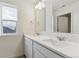 Bright bathroom featuring a double sink vanity, modern fixtures, and large mirror at 759 N Deer Park St, Watkins, CO 80137
