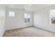 Bright bedroom with large windows and neutral carpeting at 759 N Deer Park St, Watkins, CO 80137
