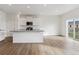Well-lit kitchen boasting white cabinets, stainless appliances, and a central island with sleek countertops at 759 N Deer Park St, Watkins, CO 80137
