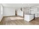 Bright and airy living space featuring wood-look floors and a seamless transition to the modern kitchen at 759 N Deer Park St, Watkins, CO 80137