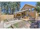 Landscaped backyard with a deck, garden beds, and outdoor seating, ideal for gardening at 1559 Elm St, Denver, CO 80220