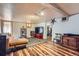 Finished basement featuring laminate floors, a sofa, and entertainment area at 1559 Elm St, Denver, CO 80220