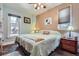 Comfortable bedroom with a floral comforter, ceiling fan, and natural light at 1559 Elm St, Denver, CO 80220