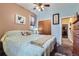 Bedroom with a floral comforter, closet, ceiling fan, and neutral-toned walls at 1559 Elm St, Denver, CO 80220