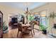 Cozy dining room featuring hardwood floors, a chandelier, and a large window overlooking the yard at 1559 Elm St, Denver, CO 80220