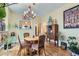 Elegant dining room featuring hardwood floors, a vintage style chandelier, and classic furnishings, perfect for gatherings at 1559 Elm St, Denver, CO 80220