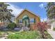 Charming single-story home featuring a quaint front porch, green shutters, and landscaped garden at 1559 Elm St, Denver, CO 80220
