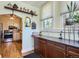 Kitchen area featuring wood cabinets, a window, and a view into the rest of the kitchen space at 1559 Elm St, Denver, CO 80220