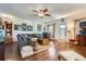 Open-concept living room featuring hardwood floors, and an entertainment area, creating a comfortable and inviting atmosphere at 1559 Elm St, Denver, CO 80220