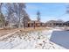 Large backyard with a swing set and partial snow coverage at 2895 Poplar St, Denver, CO 80207