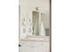 Elegant bathroom with a vanity featuring double sinks, ample lighting, and stylish decor at 150 S Harrison St # 106, Denver, CO 80209