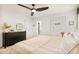 Serene bedroom with a dresser, en suite, and cozy striped bedding at 150 S Harrison St # 106, Denver, CO 80209