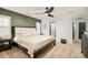 Bright bedroom featuring a ceiling fan, en suite access, and organized closet at 150 S Harrison St # 106, Denver, CO 80209