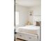 Cozy bedroom with white platform bed with storage drawers and shuttered window at 150 S Harrison St # 106, Denver, CO 80209