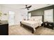 Spacious bedroom with a king-sized bed, stylish green wall, and view to en suite bathroom at 150 S Harrison St # 106, Denver, CO 80209