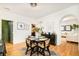 Charming dining area with a round table, modern chairs, and views into the living room at 150 S Harrison St # 106, Denver, CO 80209