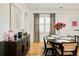 Dining room with dark wood accents, hardwood floors, and designer curtains at 150 S Harrison St # 106, Denver, CO 80209