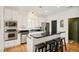 Modern kitchen with stainless steel appliances, black countertops, and breakfast bar at 150 S Harrison St # 106, Denver, CO 80209