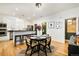 Well-lit kitchen and dining area with a black table and island seating at 150 S Harrison St # 106, Denver, CO 80209