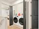 Laundry area with modern front-loading washer and dryer at 150 S Harrison St # 106, Denver, CO 80209
