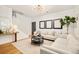 Spacious living room with hardwood floors, neutral decor, and ample seating at 150 S Harrison St # 106, Denver, CO 80209