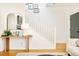 Bright staircase with white railings and a stylish console table at 150 S Harrison St # 106, Denver, CO 80209