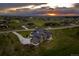 Aerial view of home showcasing its premium lot, driveway, and surrounding neighborhood at sunset at 2442 Fox View Trl, Franktown, CO 80116