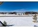Stunning aerial view of homes with snow and mountain views at 2442 Fox View Trl, Franktown, CO 80116