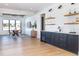 Stylish basement bar with dark cabinets and a wet bar at 2442 Fox View Trl, Franktown, CO 80116