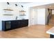 Modern basement bar with dark cabinetry and floating shelves at 2442 Fox View Trl, Franktown, CO 80116