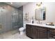 Elegant bathroom with gray tile shower and double vanity at 2442 Fox View Trl, Franktown, CO 80116