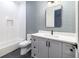 Modern bathroom with geometric tile and gray vanity at 2442 Fox View Trl, Franktown, CO 80116