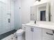 Bright bathroom featuring a glass shower, white vanity, and stylish tile flooring, offering a modern aesthetic at 2442 Fox View Trl, Franktown, CO 80116