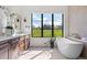 Bathroom with a soaking tub and a view at 2442 Fox View Trl, Franktown, CO 80116