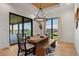 Stylish dining room with wooden table, bench seating, and contemporary lighting at 2442 Fox View Trl, Franktown, CO 80116