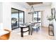 Elegant dining room with large windows and modern chandelier at 2442 Fox View Trl, Franktown, CO 80116