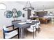 Bright dining room features a large table with seating for six and a modern chandelier at 2442 Fox View Trl, Franktown, CO 80116