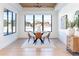 Elegant dining room with large windows and hardwood floors at 2442 Fox View Trl, Franktown, CO 80116