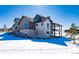 Luxury home exterior with stone accents and a large deck at 2442 Fox View Trl, Franktown, CO 80116