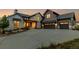 Stunning home with stone and siding and three-car garage, set against a picturesque landscape at 2442 Fox View Trl, Franktown, CO 80116