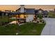 Beautiful home features a stone facade, covered deck and three car garage at 2442 Fox View Trl, Franktown, CO 80116