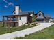 Captivating exterior view of home featuring a stone facade, grey wood, three-car garage and manicured landscaping at 2442 Fox View Trl, Franktown, CO 80116
