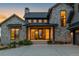 Inviting stone home with a covered front entrance and manicured landscaping at 2442 Fox View Trl, Franktown, CO 80116