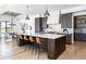 Modern kitchen with dark cabinetry and large island at 2442 Fox View Trl, Franktown, CO 80116