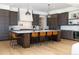 Modern kitchen with an island, stainless steel appliances, and custom cabinetry at 2442 Fox View Trl, Franktown, CO 80116