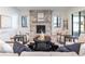 Spacious living room with a stone fireplace and comfortable seating area at 2442 Fox View Trl, Franktown, CO 80116