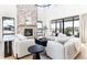Open living area with a cozy fireplace and ample natural light at 2442 Fox View Trl, Franktown, CO 80116