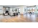 Bright living room with stone fireplace, hardwood floors, and sliding glass doors at 2442 Fox View Trl, Franktown, CO 80116