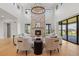 Bright living room with a floor to ceiling stone fireplace and wood floors at 2442 Fox View Trl, Franktown, CO 80116